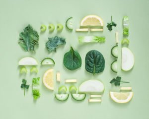 Photo of artfully arranged green fruits and vegetables